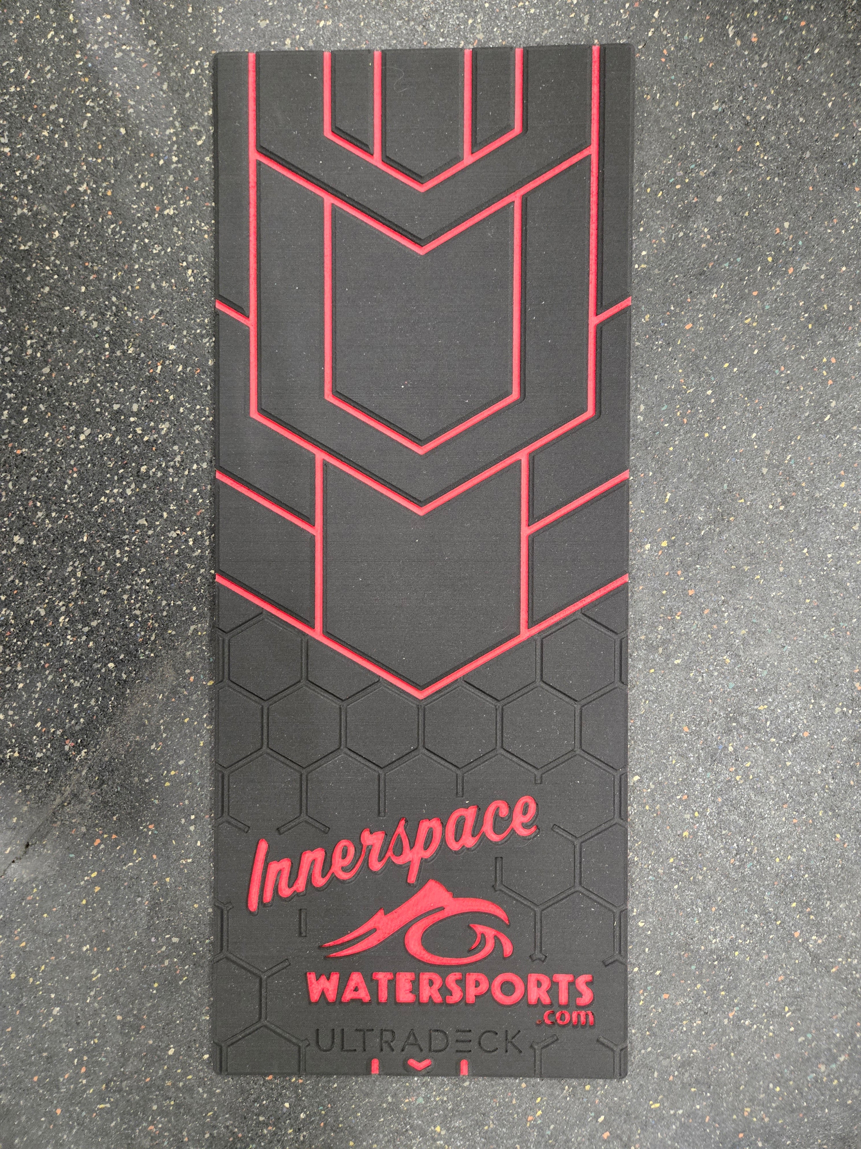 Black and red Innerspace Watersports mat on a gray surface