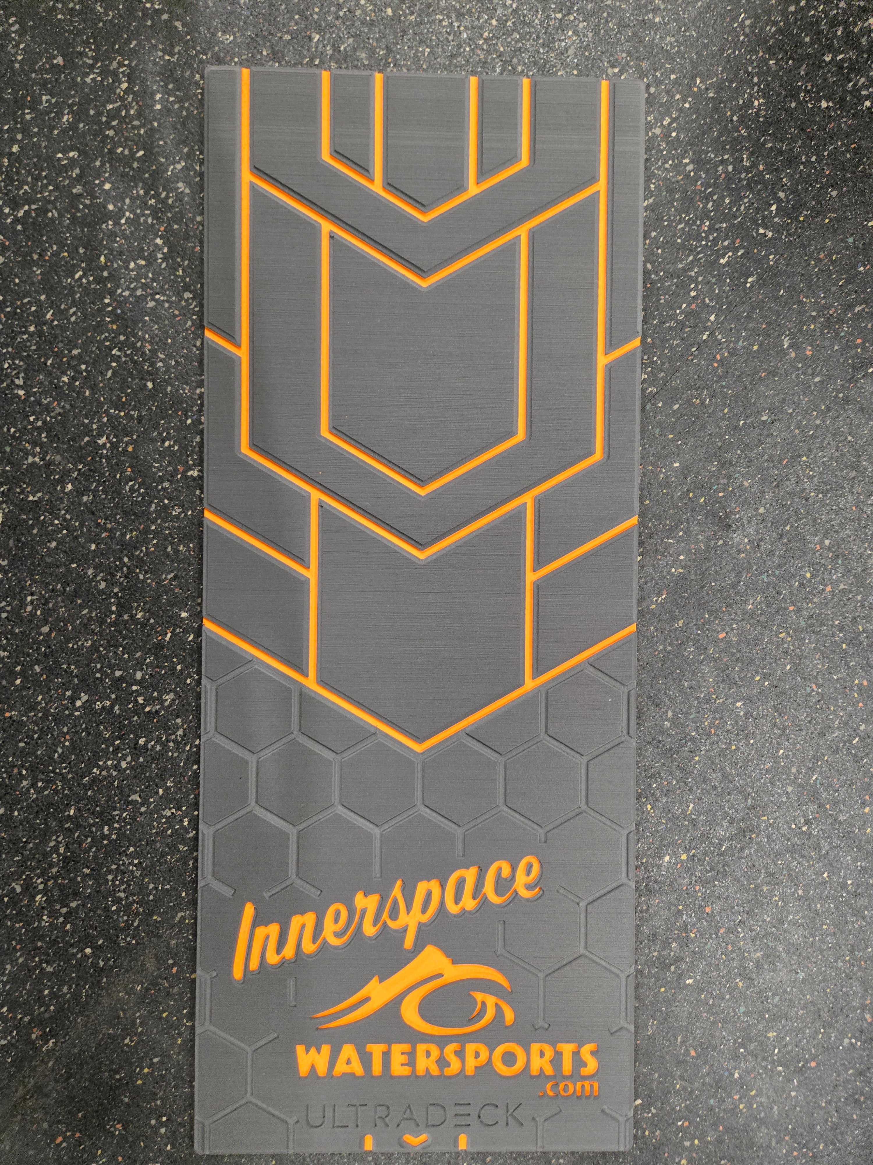 Gray and orange watersports mat with 'Innerspace Watersports' branding on a dark textured background