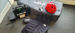 MSLR equipment including a helmet, bag, and foot pedals on a floor.