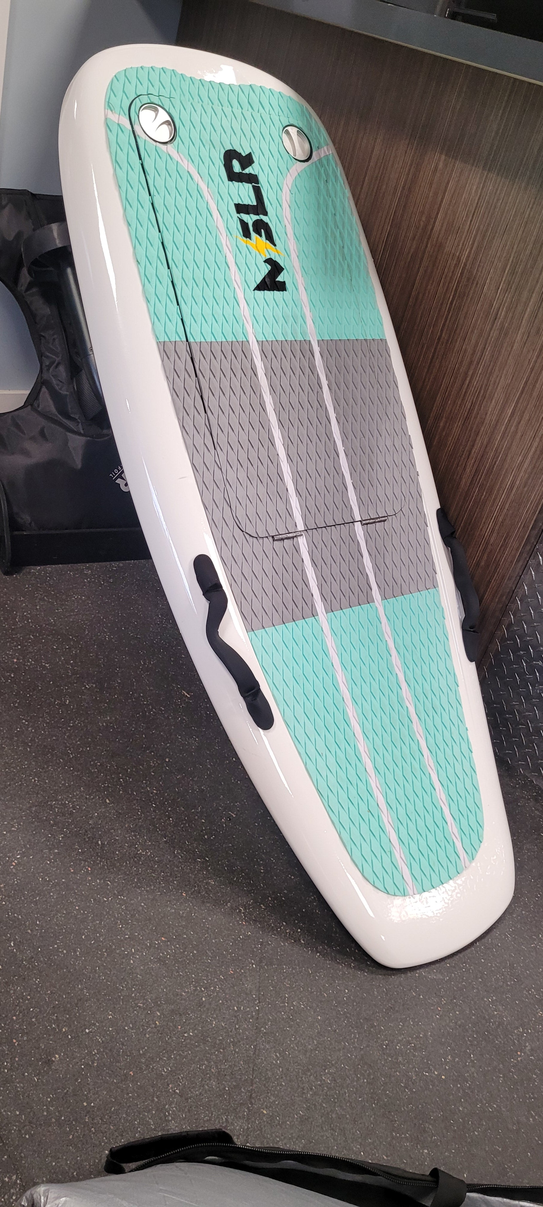 Supboard with teal and gray design on a dark surface