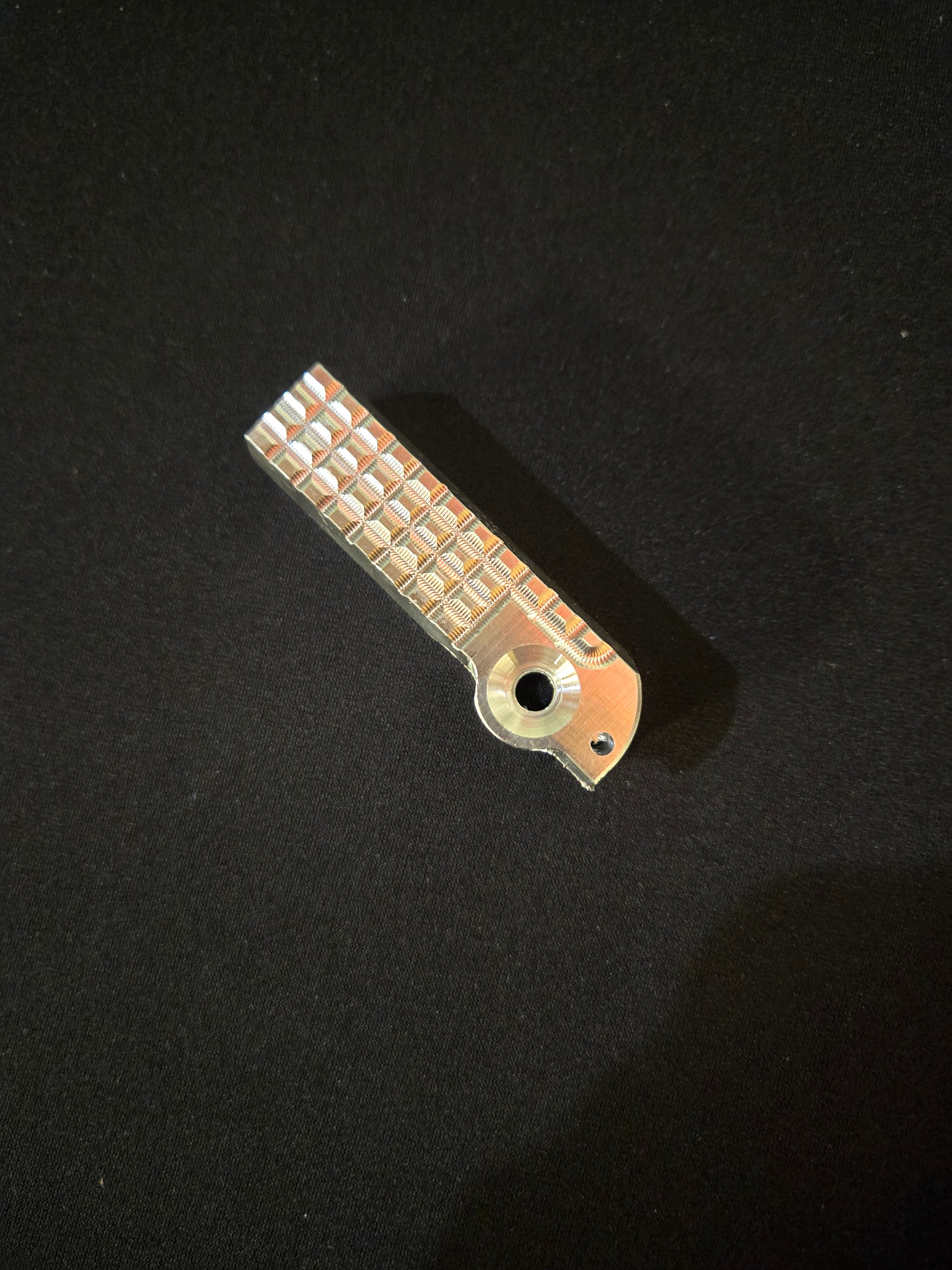 Metallic object with textured surface on a black background