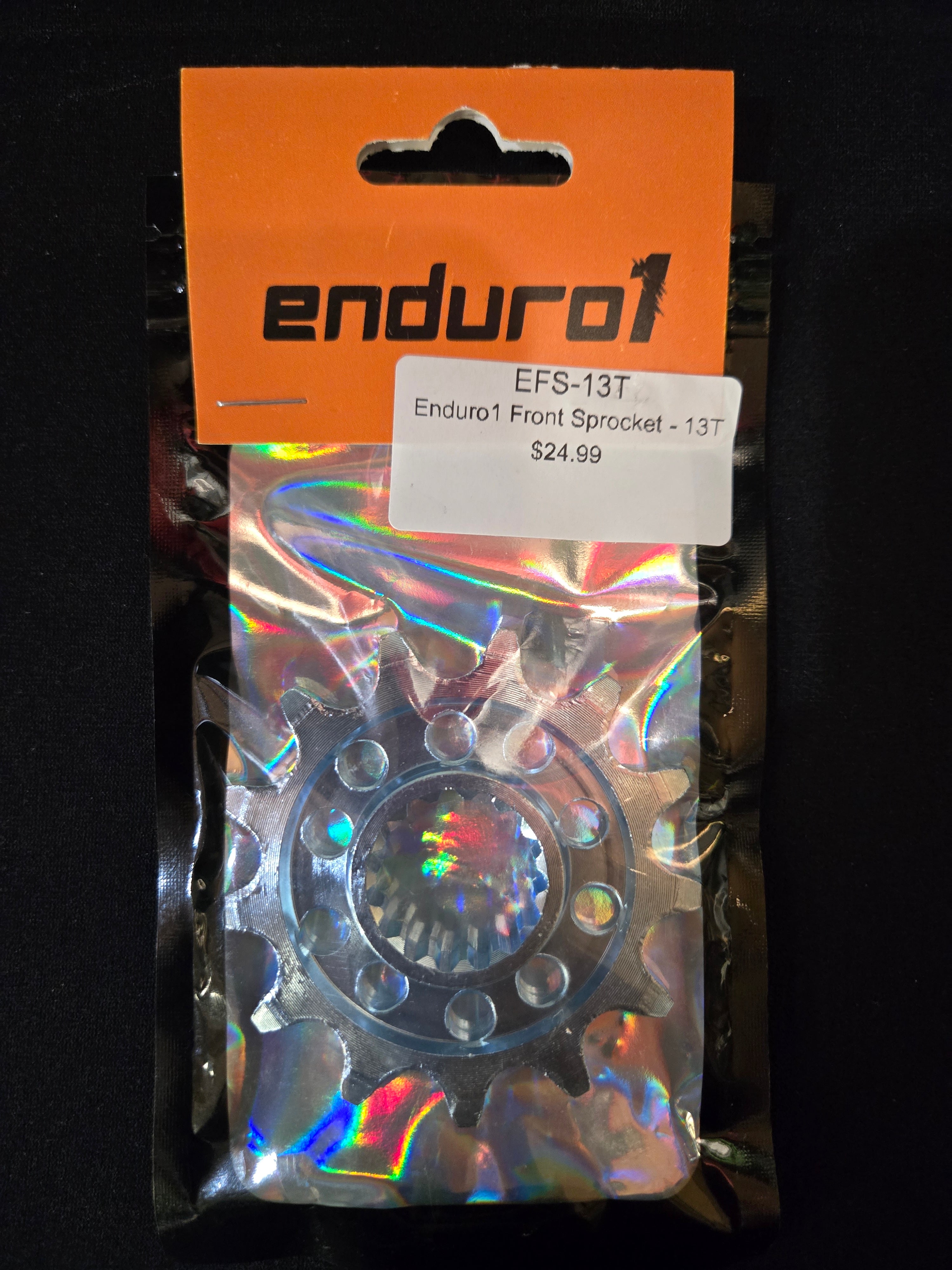 Enduro1 front sprocket in packaging with orange card and price tag on a black background