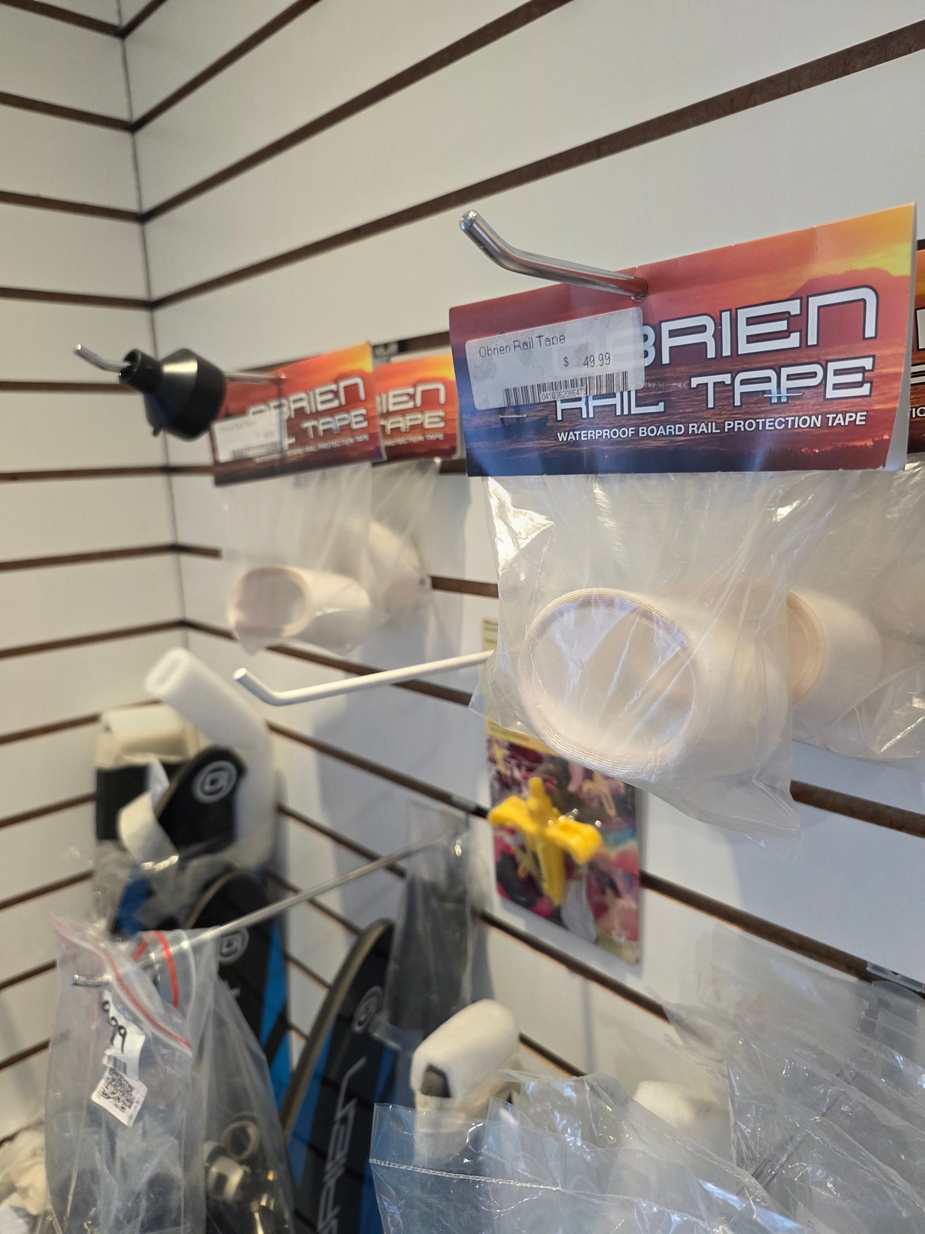Display of Alien Tape products on a white rack with clear plastic packaging.