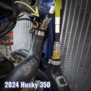 Close-up of a motorcycle's exhaust system with '2024 Husky 350' text.