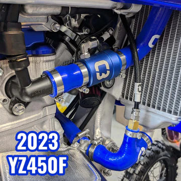 Close-up of a motorcycle's engine with blue components and '2023 YZ450F' text.