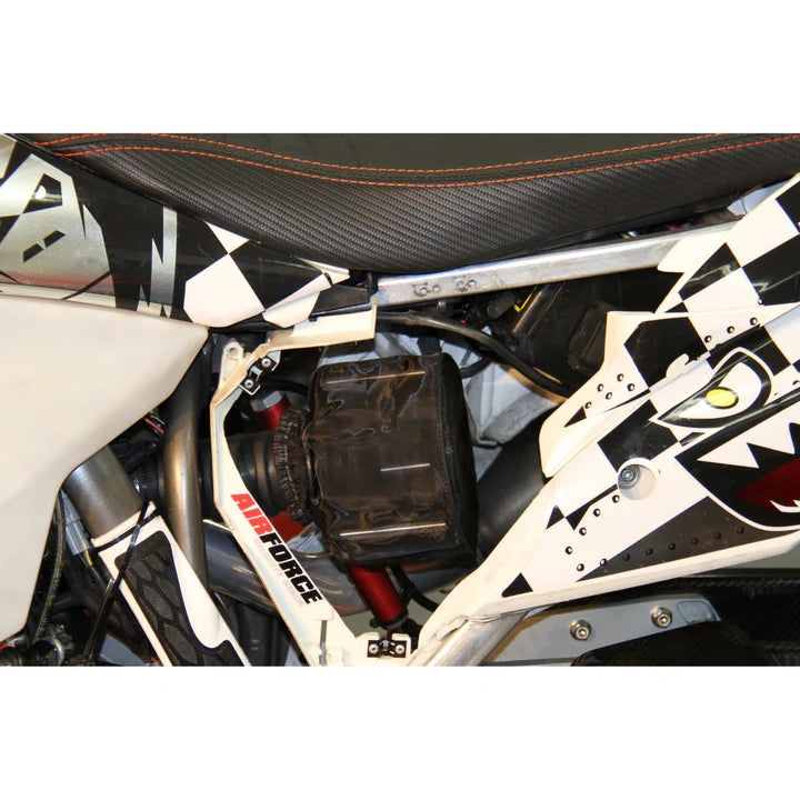 Close-up of a motorcycle with a checkered pattern and visible branding.