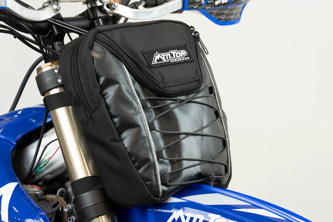 Black motorcycle saddlebag with Antitop branding on a blue motorcycle.
