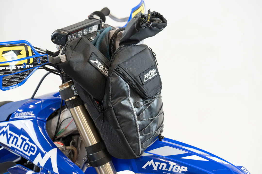 Black motorcycle saddlebags attached to a blue Yamaha motorcycle on a white background