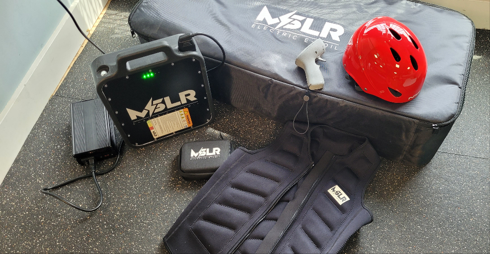 MCLR branded equipment including a helmet, battery pack, and case on a concrete floor.