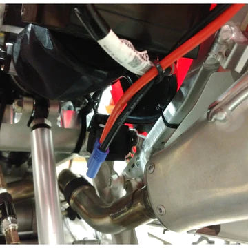 Close-up of motorcycle wiring and exhaust system