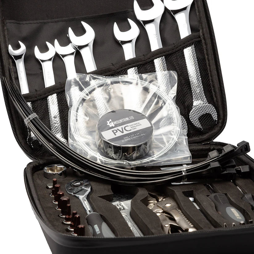 Open tool case with various tools including wrenches and a fan, on a white background