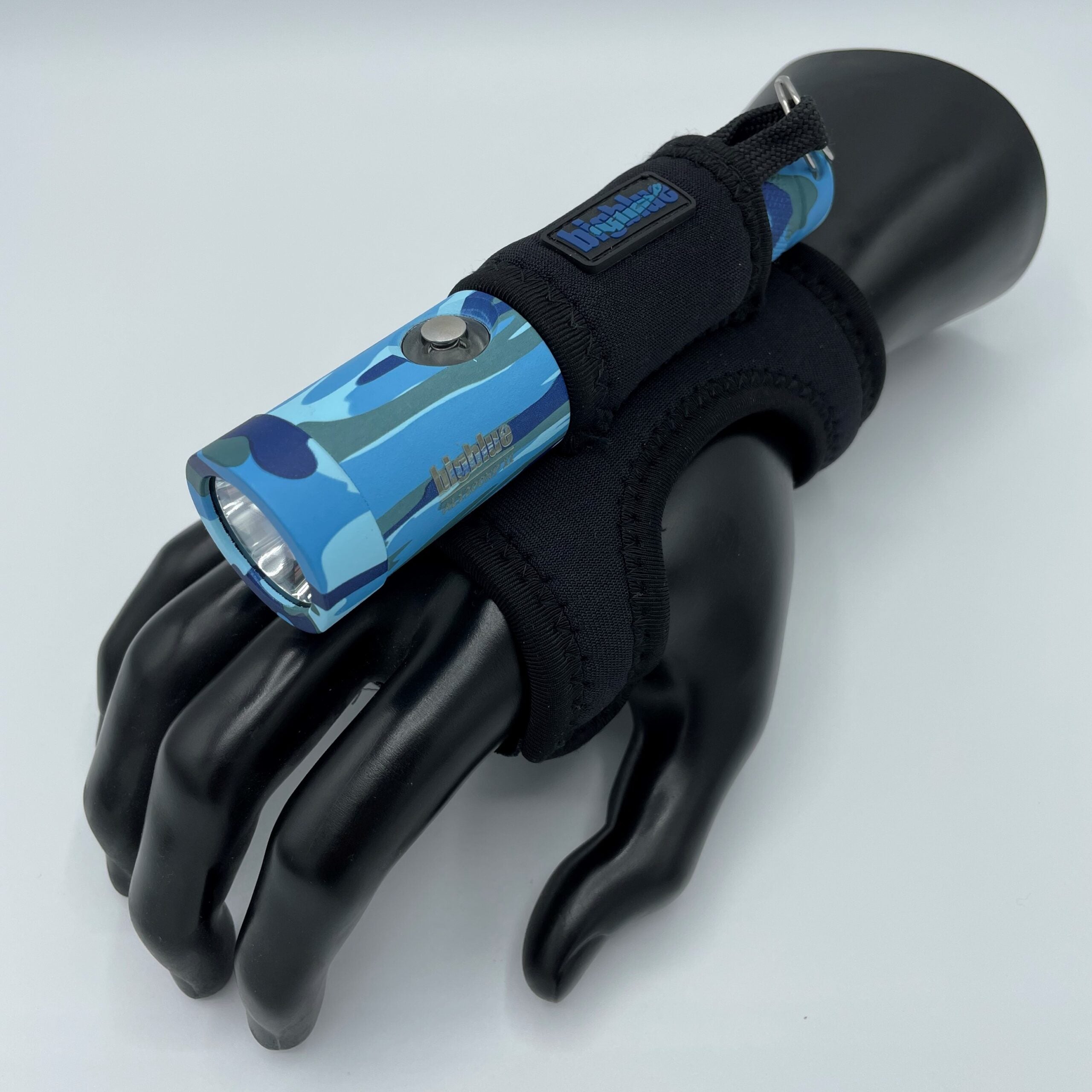 Black glove with a blue flashlight on a white background