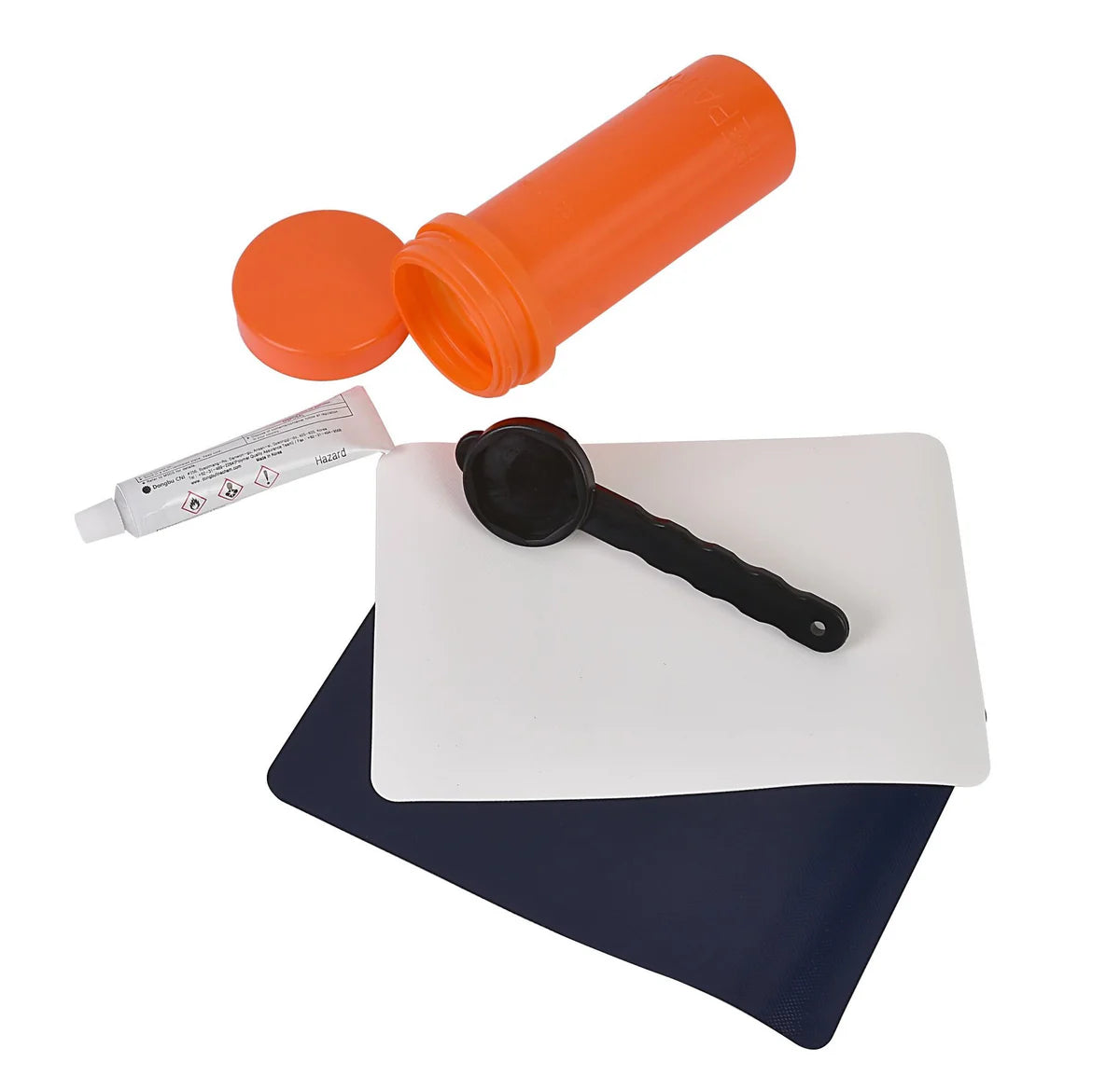 Set of items including an orange container, a white pad with a black tool, and a blue mat on a white background.