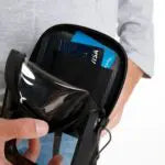 Person holding a black bag with a blue interior