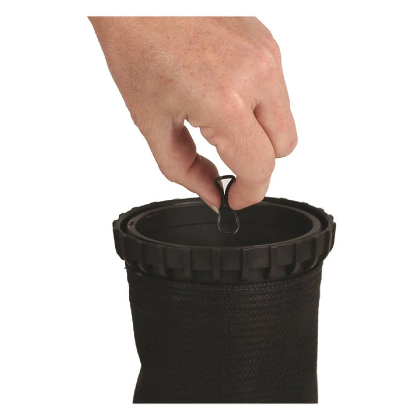 Hand placing a small object into a black container on a white background