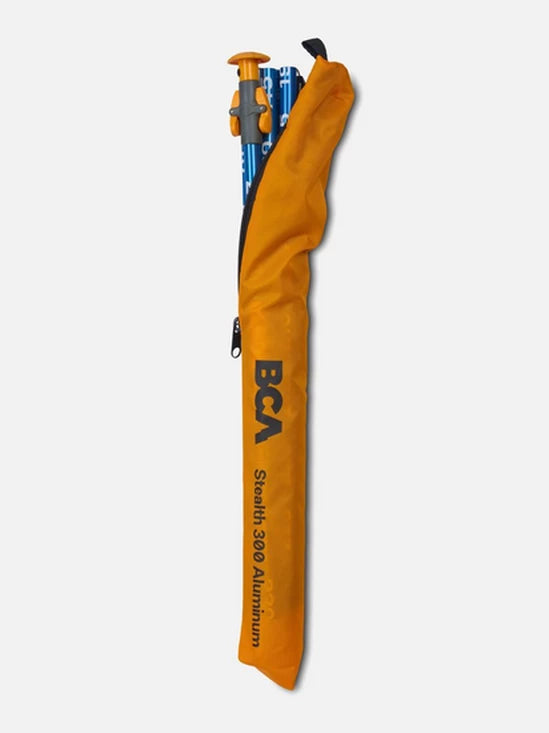 Orange carrying case with a climbing pole inside on a white background, featuring BCA branding.