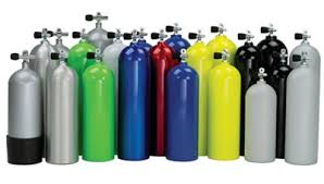 Collection of various colored scuba diving tanks arranged in a row.