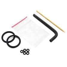 Set of black rubber gaskets and a plastic tool on a white background