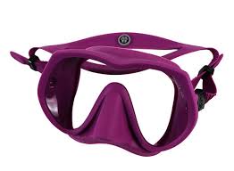 A purple silicone diving mask with a single large lens, nose piece, and adjustable strap system, shown against a plain white background.