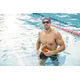 Man swimming in a pool with a swim cap on