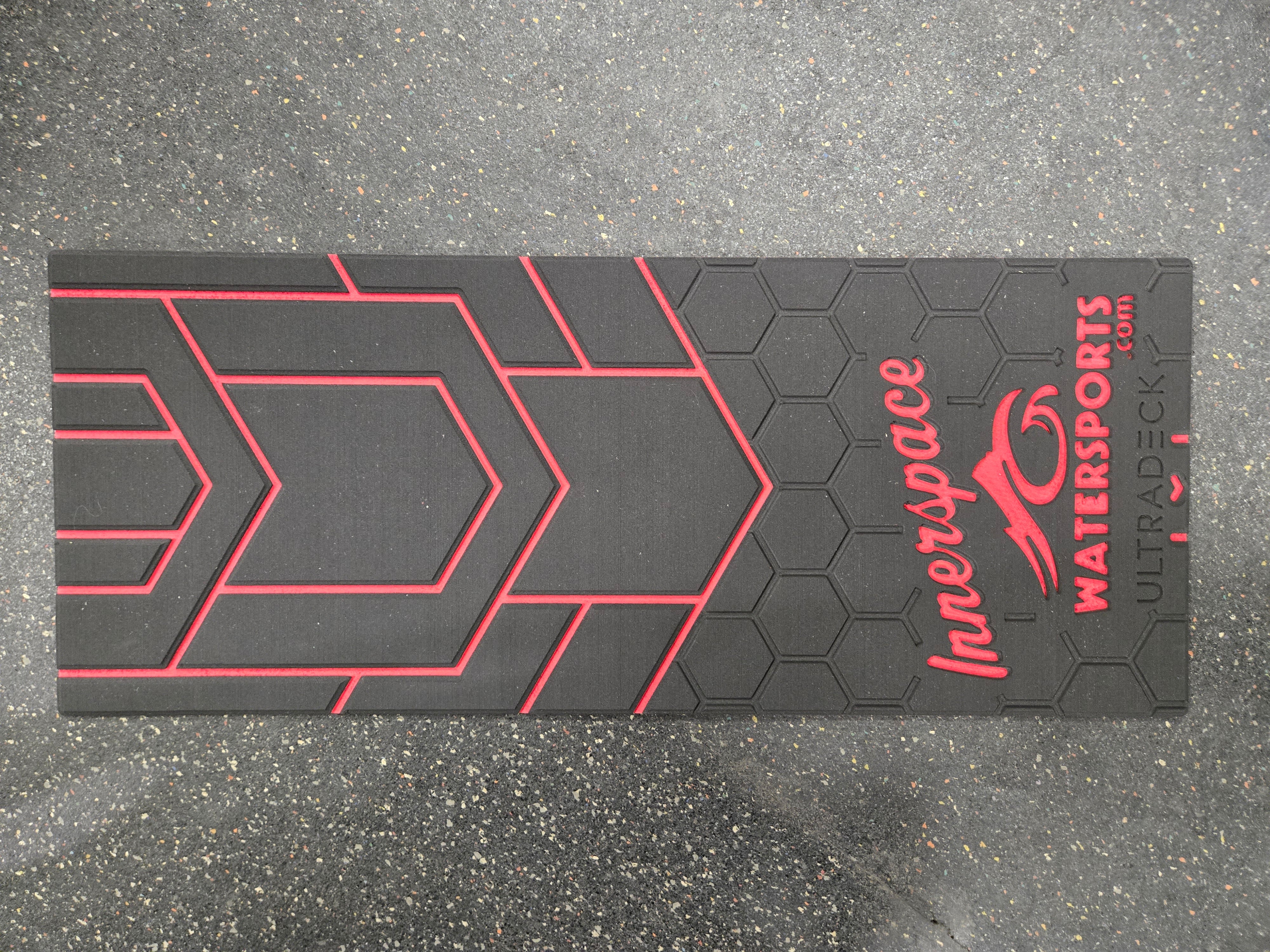 Black mat with red geometric patterns and 'Innerspace Watersports' branding on a gray surface.