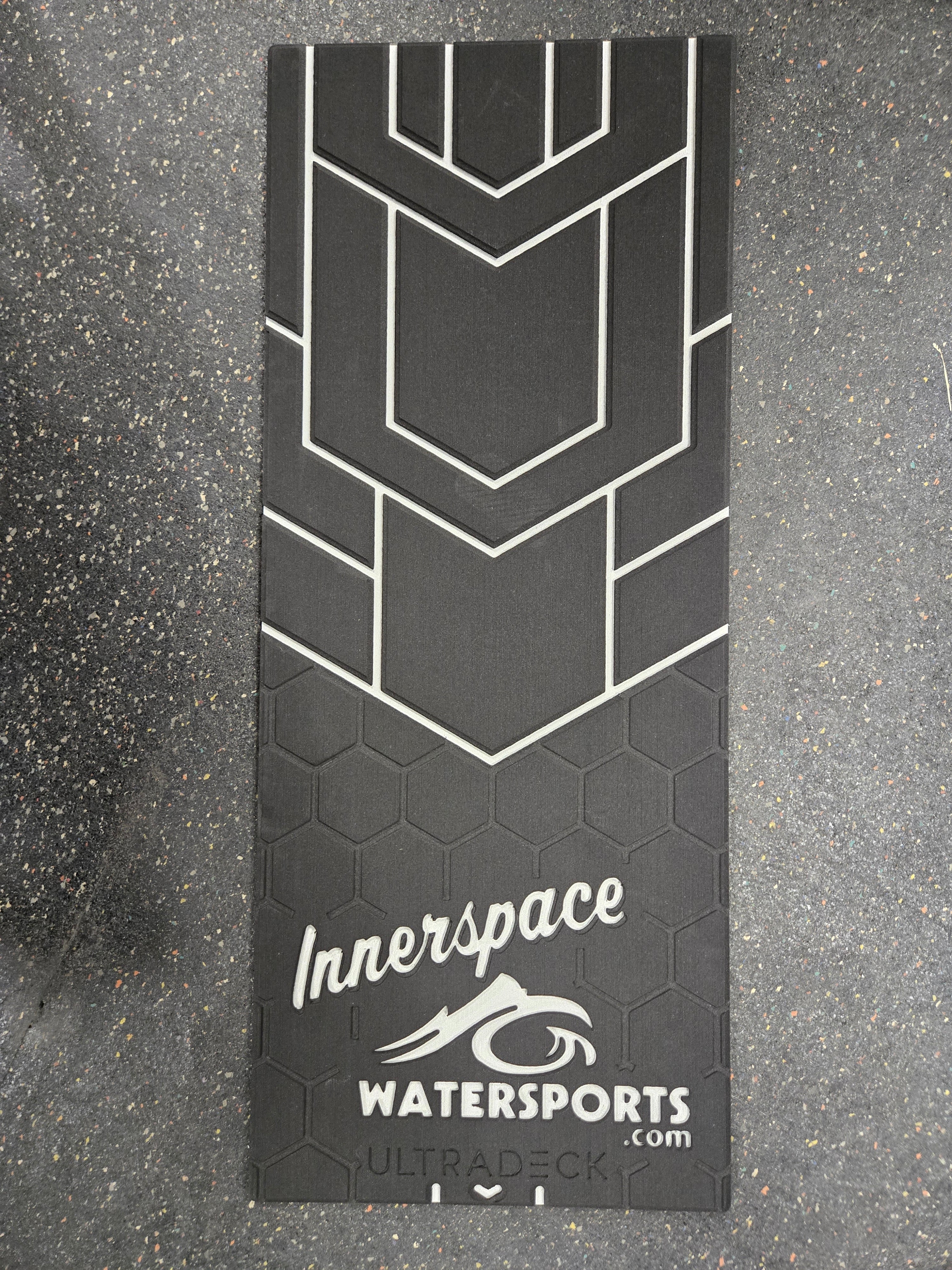 Black and white Innerspace Watersports mat on a gray surface
