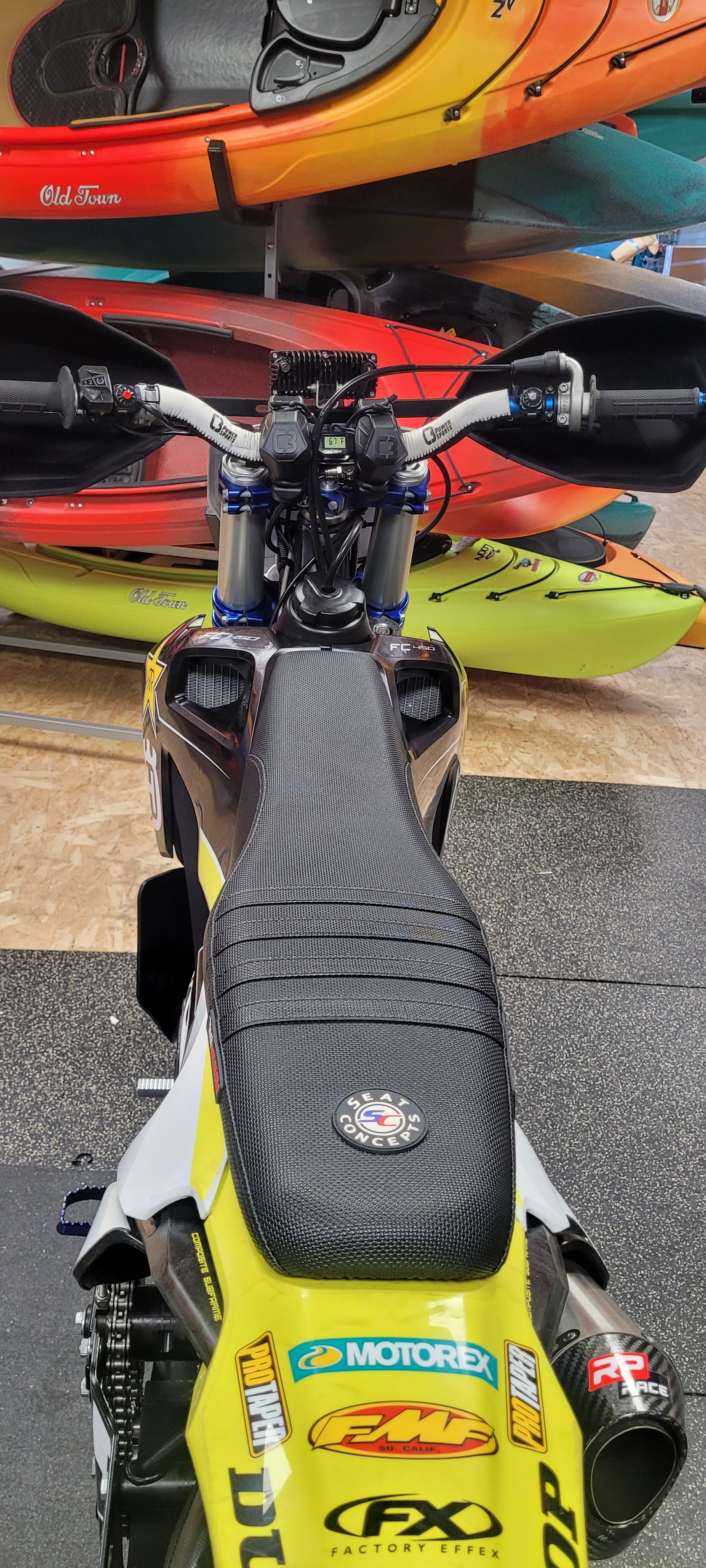 Close-up of a motorcycle seat with visible branding on a textured surface